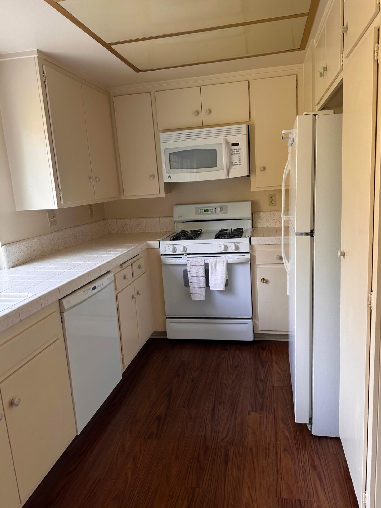 7248 Georgetown Road Goleta, CA 93117 - Photo 6 of 9 a kitchen with a stove a refrigerator and a microwave