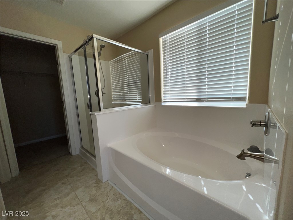6592 Benvolio Court Las Vegas, NV 89141 - Photo 11 of 27 Bathroom with a garden tub, a spacious closet, and a shower stall
