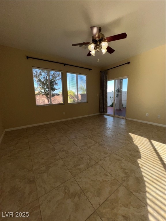 6592 Benvolio Court Las Vegas, NV 89141 - Photo 25 of 27 Empty room with healthy amount of natural light, light tile patterned floors, and a ceiling fan