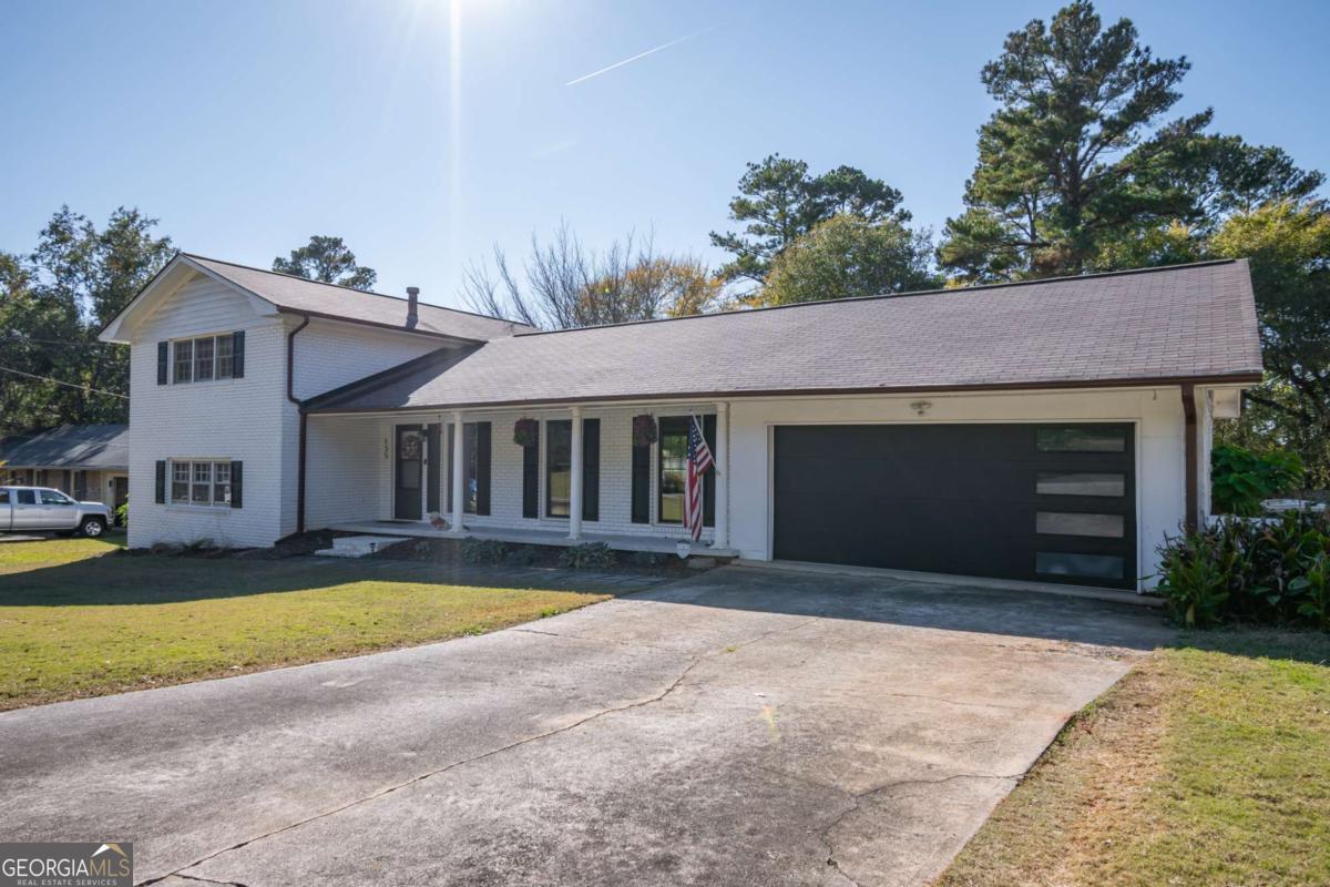 135 Tara Way Athens, GA 30606 - Photo 1 of 36 a front view of a house with a yard and garage