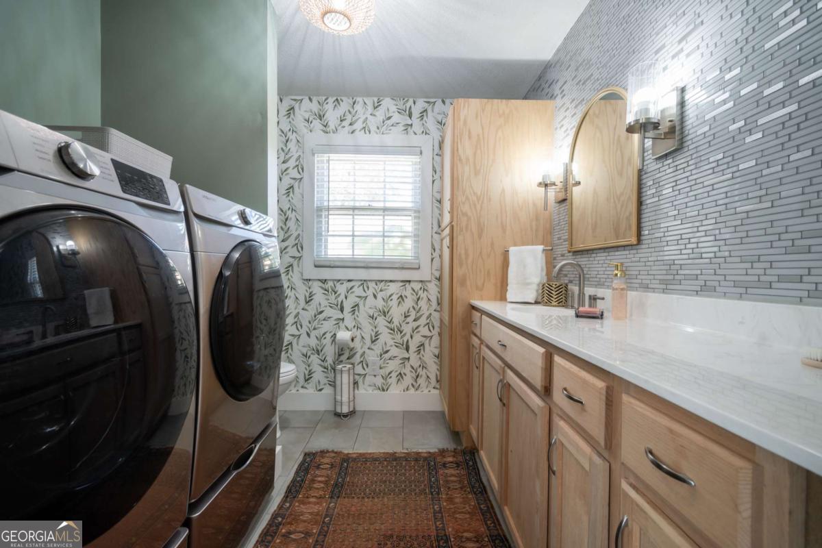135 Tara Way Athens, GA 30606 - Photo 11 of 36 a bathroom with a sink a toilet and mirror