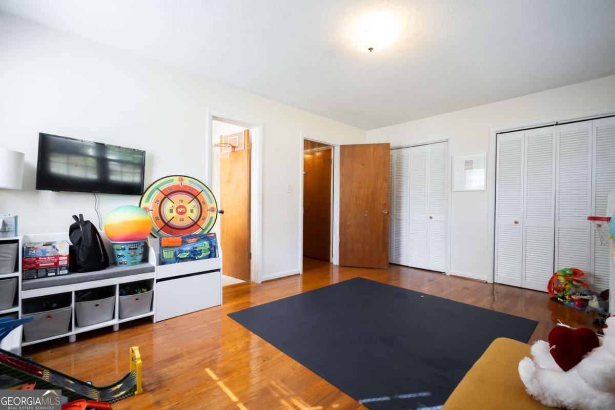 135 Tara Way Athens, GA 30606 - Photo 16 of 36 a living room with furniture a flat screen tv and a large window