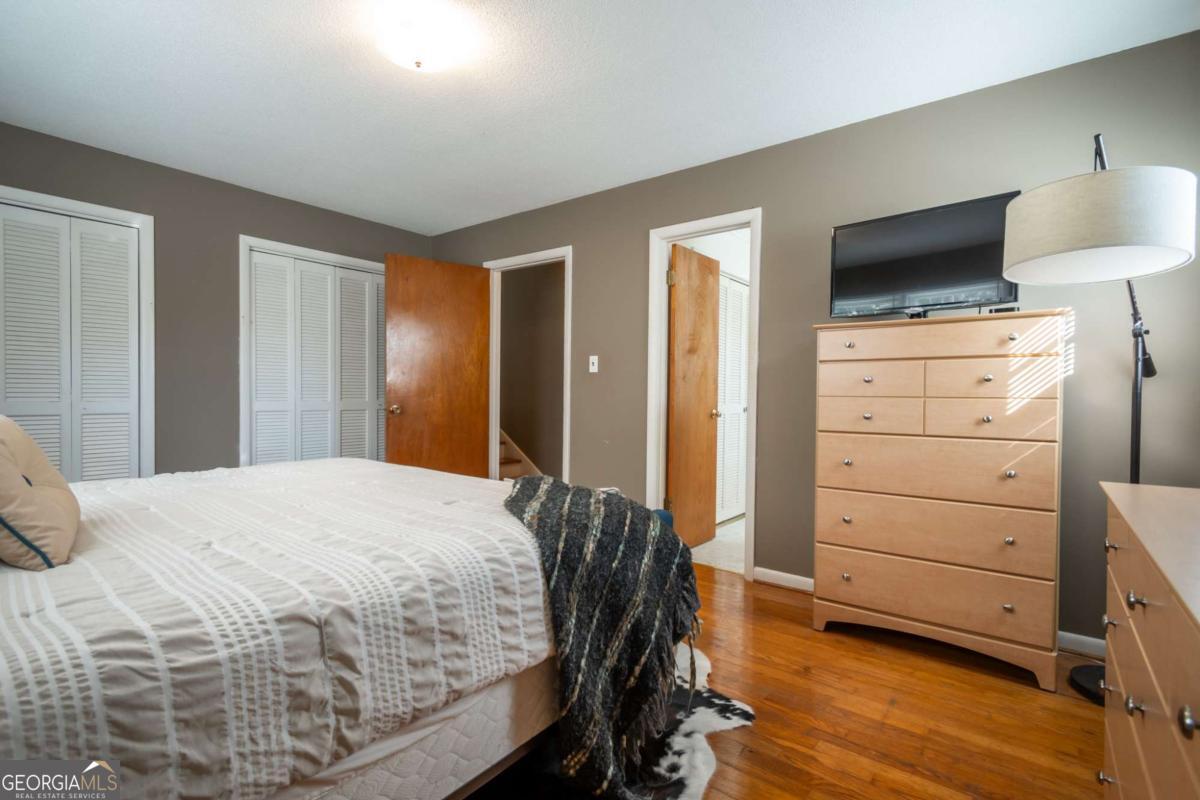 135 Tara Way Athens, GA 30606 - Photo 21 of 36 a bedroom with a bed and a flat tv screen in it