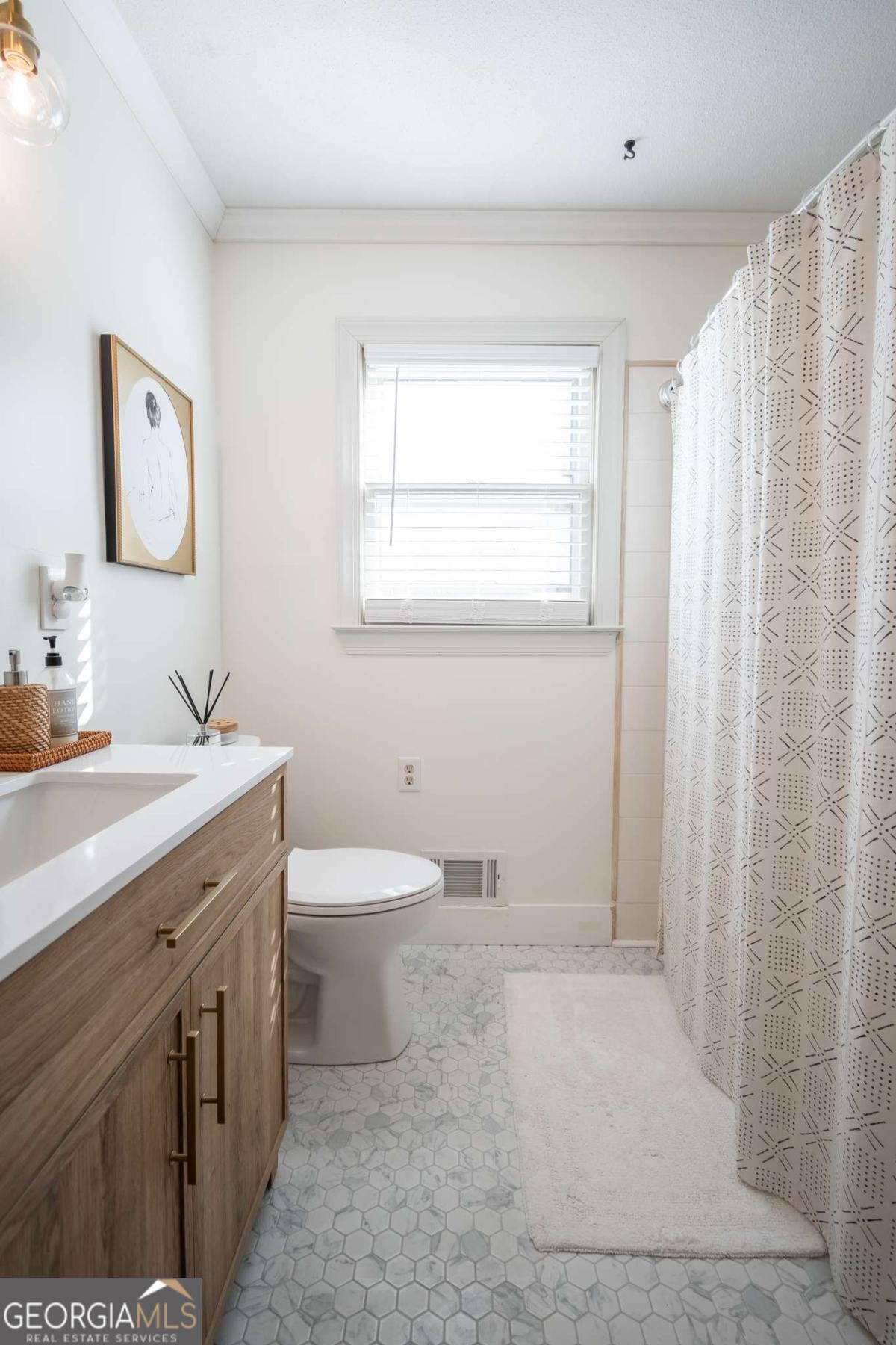 135 Tara Way Athens, GA 30606 - Photo 24 of 36 a bathroom with a double vanity sink toilet and a mirror