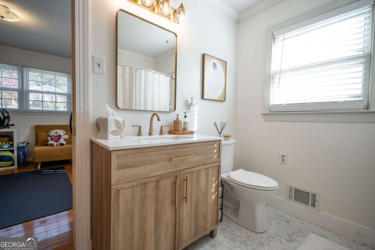 135 Tara Way Athens, GA 30606 - Photo 25 of 36 a bathroom with a toilet a sink and mirror
