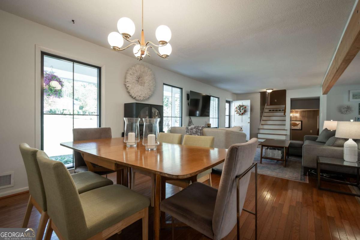 135 Tara Way Athens, GA 30606 - Photo 6 of 36 a view of a dining room with furniture window and wooden floor