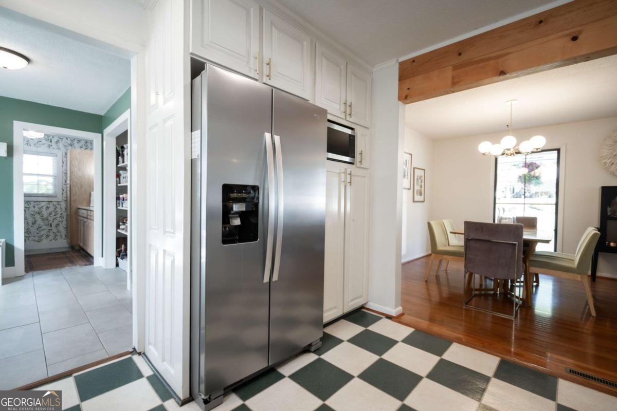 135 Tara Way Athens, GA 30606 - Photo 8 of 36 a kitchen with stainless steel appliances granite countertop a refrigerator and a dining table
