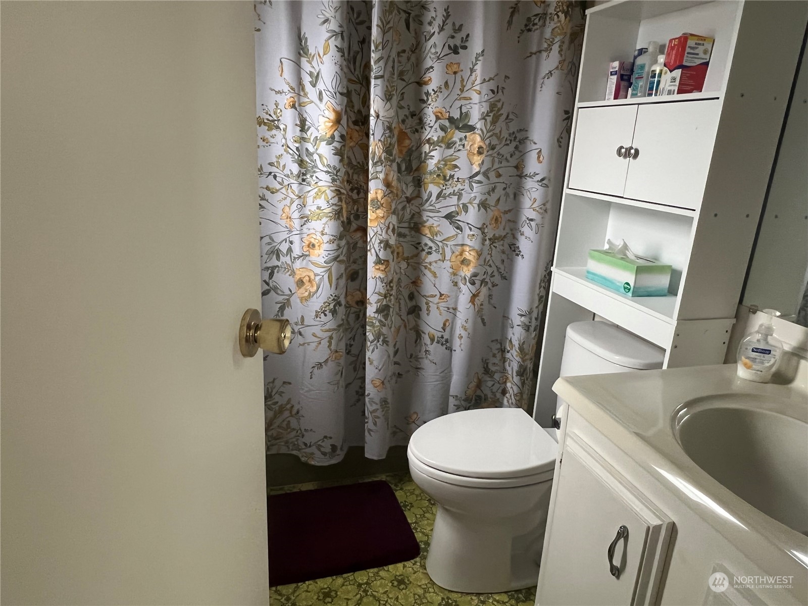 11622 Silver Lake Road, Unit 55 Everett, WA 98208 - Photo 12 of 17 a bathroom with a toilet sink and shower curtain