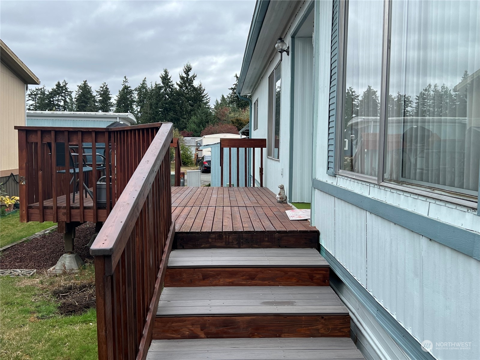11622 Silver Lake Road, Unit 55 Everett, WA 98208 - Photo 3 of 17 a view of a balcony with wooden floor and outdoor space