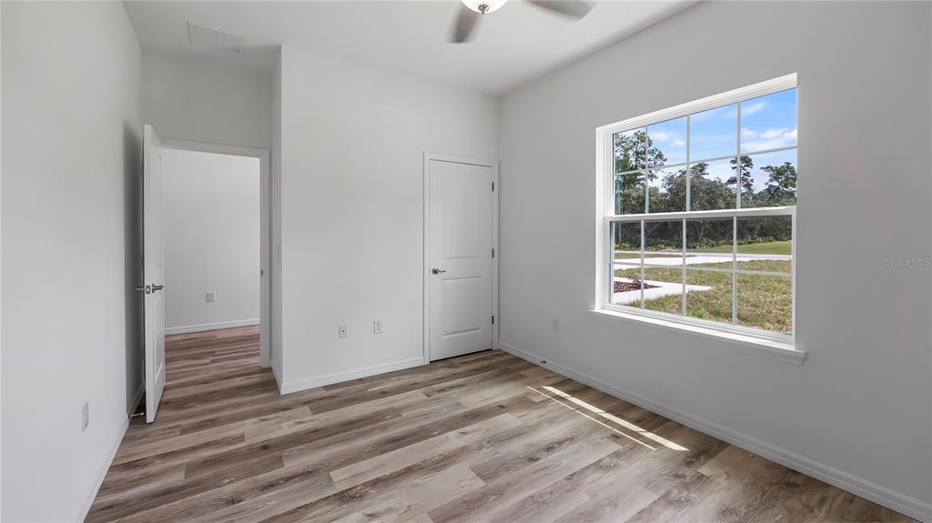 40407 West 8th Avenue Umatilla, FL 32784 - Photo 22 of 26 an empty room with wooden floor and windows