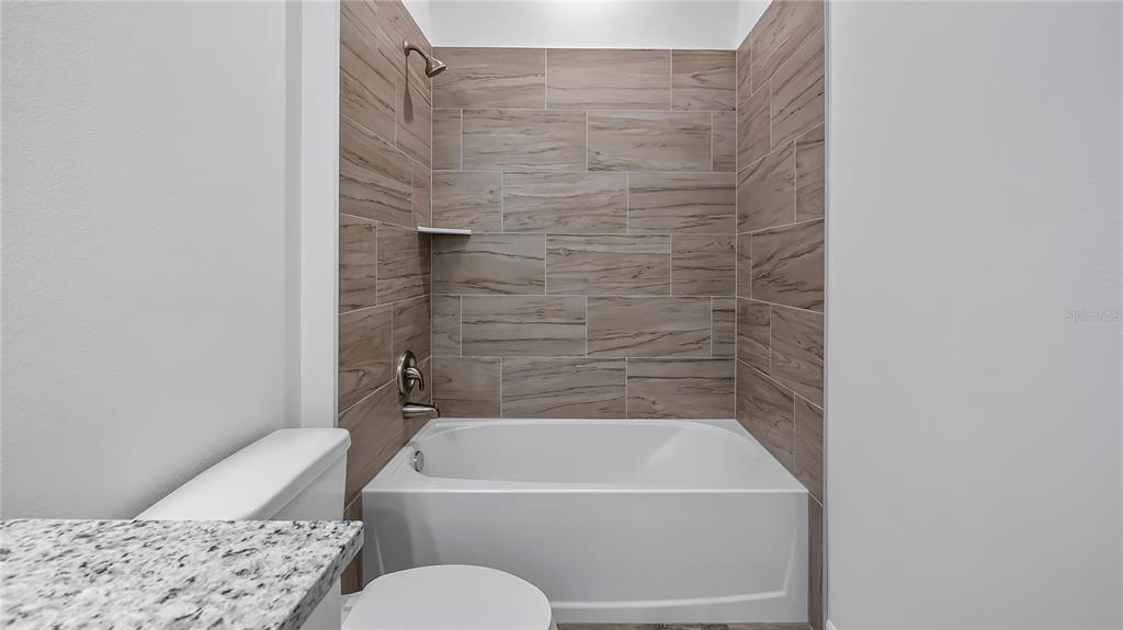 40407 West 8th Avenue Umatilla, FL 32784 - Photo 24 of 26 a bathroom with a bathtub and a toilet