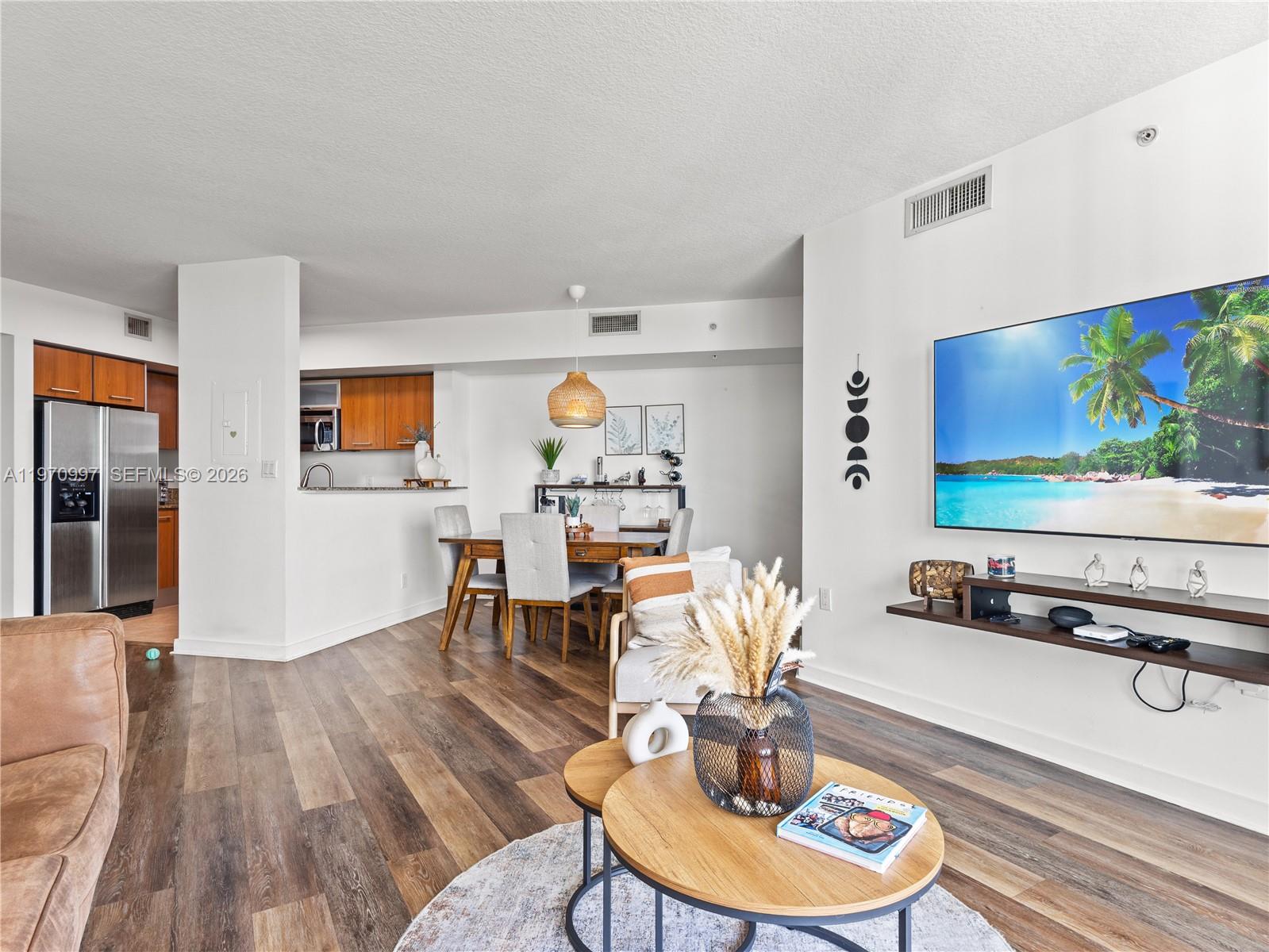 9066 Southwest 73rd Court, Unit 2008 Miami, FL 33156 - Photo 11 of 35 a living room with furniture and a flat screen tv