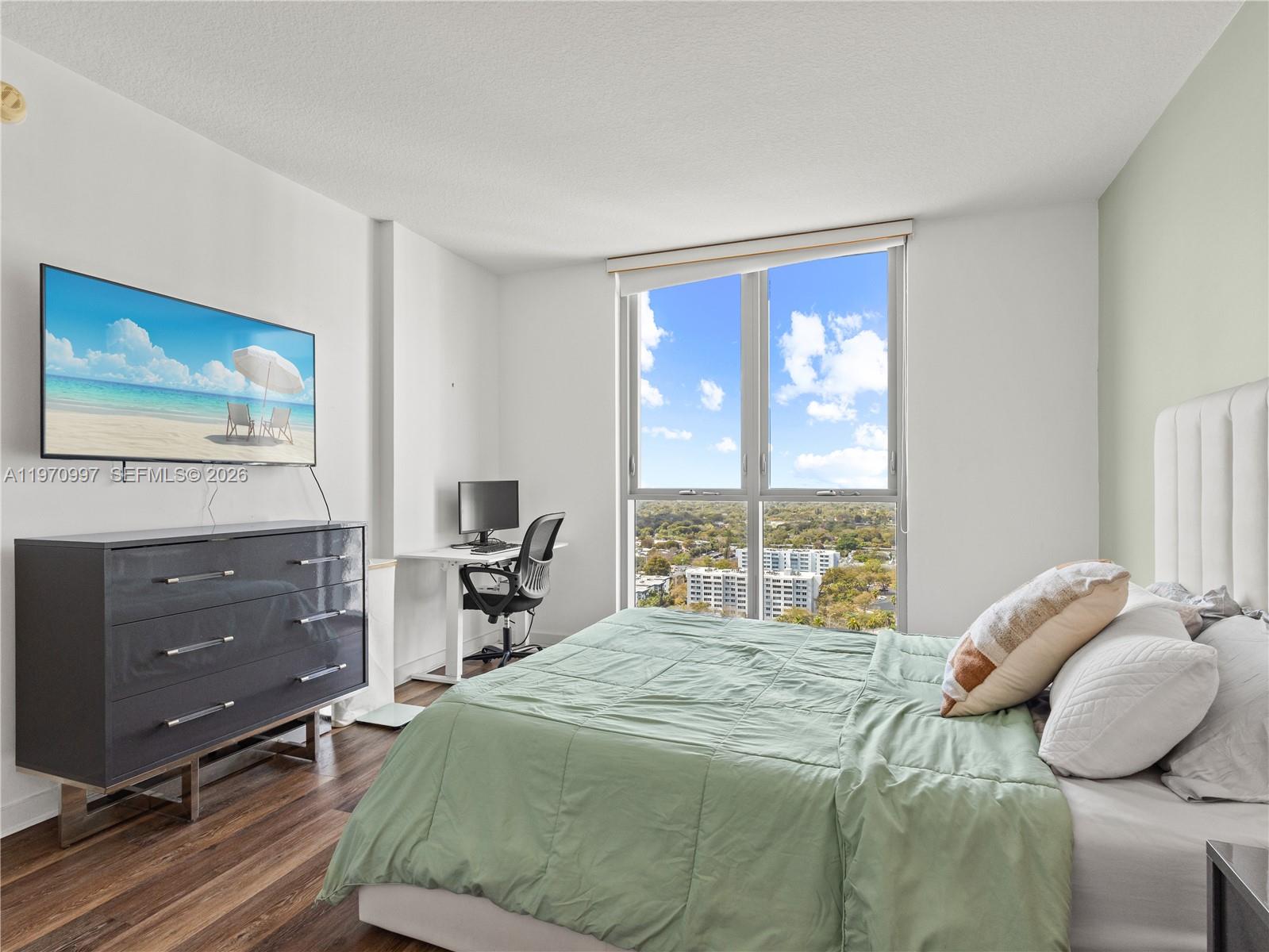 9066 Southwest 73rd Court, Unit 2008 Miami, FL 33156 - Photo 17 of 35 a bedroom with a bed and window