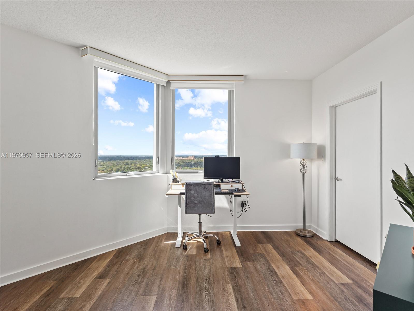9066 Southwest 73rd Court, Unit 2008 Miami, FL 33156 - Photo 22 of 35 a view of a workspace with wooden floor and a window