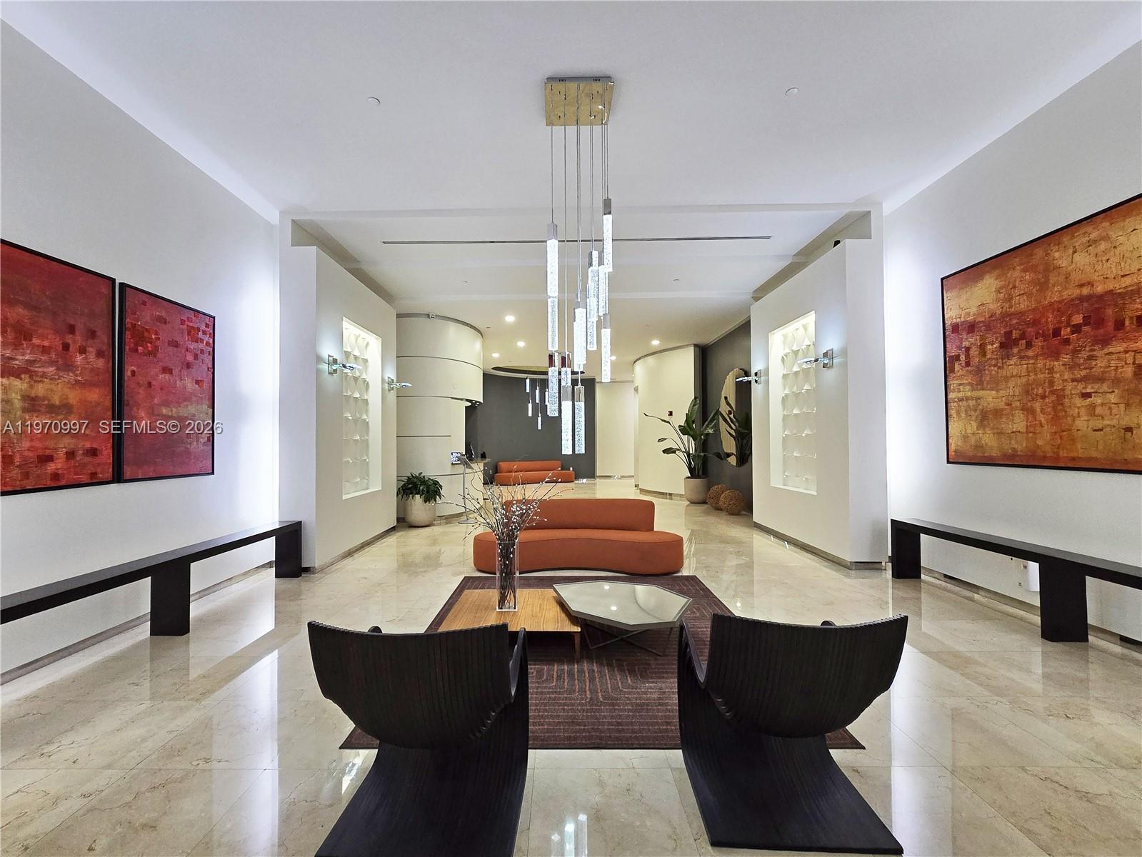 9066 Southwest 73rd Court, Unit 2008 Miami, FL 33156 - Photo 27 of 35 a living room with furniture and a chandelier