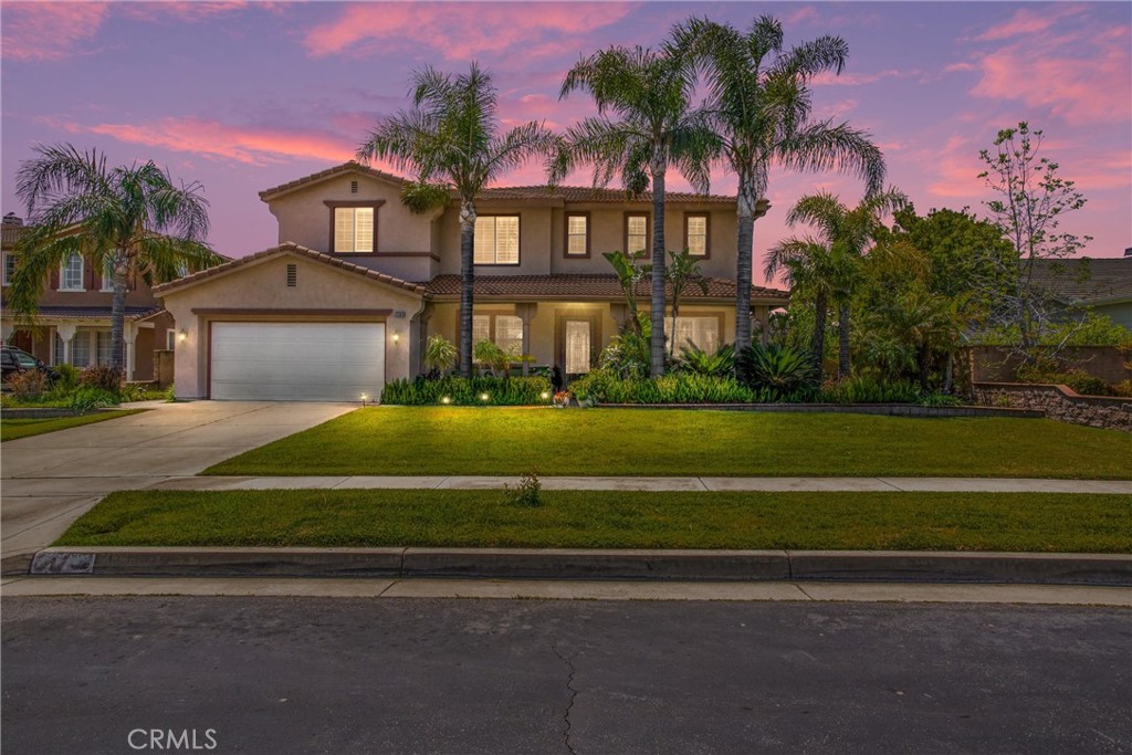 13393 Redwood Drive Rancho Cucamonga, CA 91739 - Photo 1 of 1 a front view of a house with a garden and trees