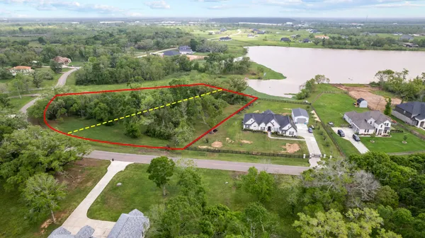 an aerial view of river residential houses with outdoor space and swimming pool