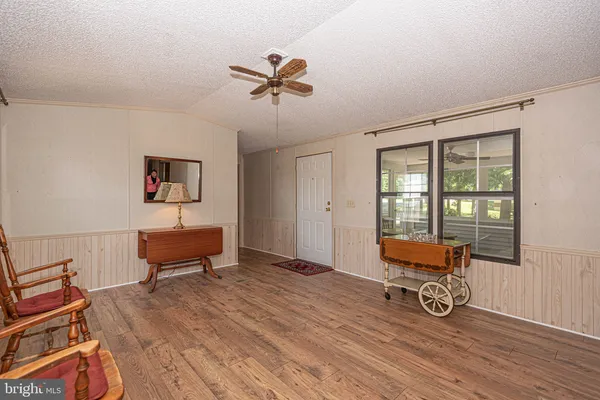 a view of room with lounge chair and wooden floor