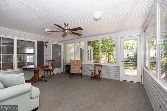 a living room with furniture and large windows