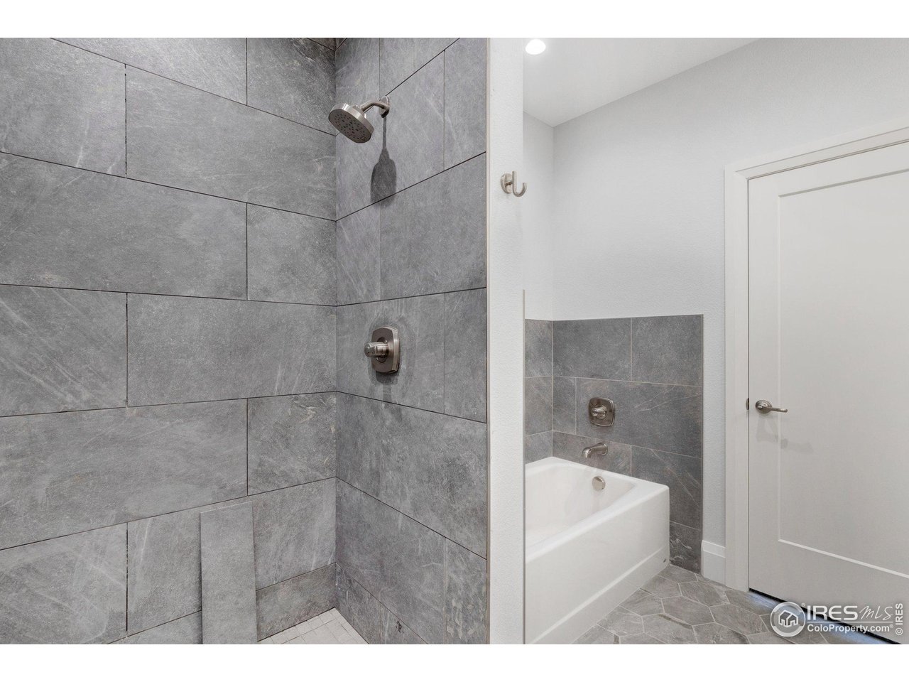 5700 2nd Road Greeley, CO 80634 - Photo 22 of 40 Floor-to-ceiling tile in the large shower, plus a real cast iron tub