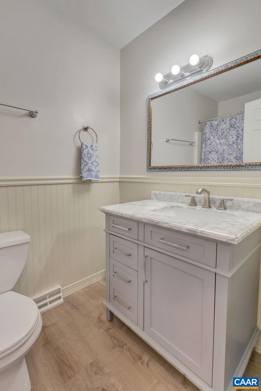 385 Gillums Ridge Road Charlottesville, VA 22903 - Photo 11 of 34 a bathroom with a granite countertop sink a toilet and a mirror