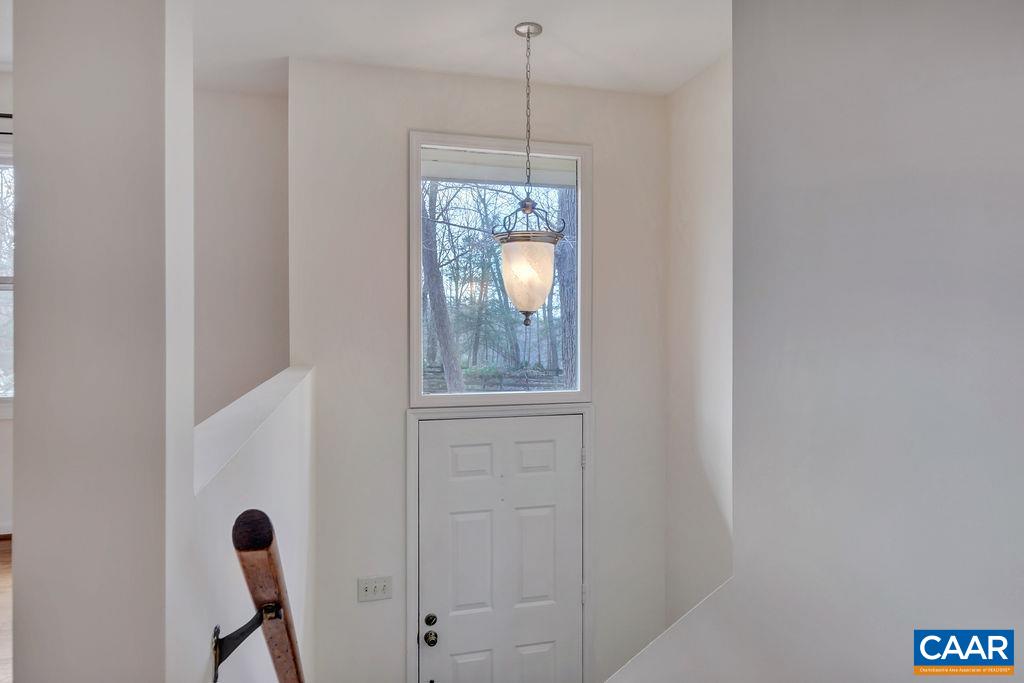 385 Gillums Ridge Road Charlottesville, VA 22903 - Photo 13 of 34 a view of a hallway with windows and chandelier