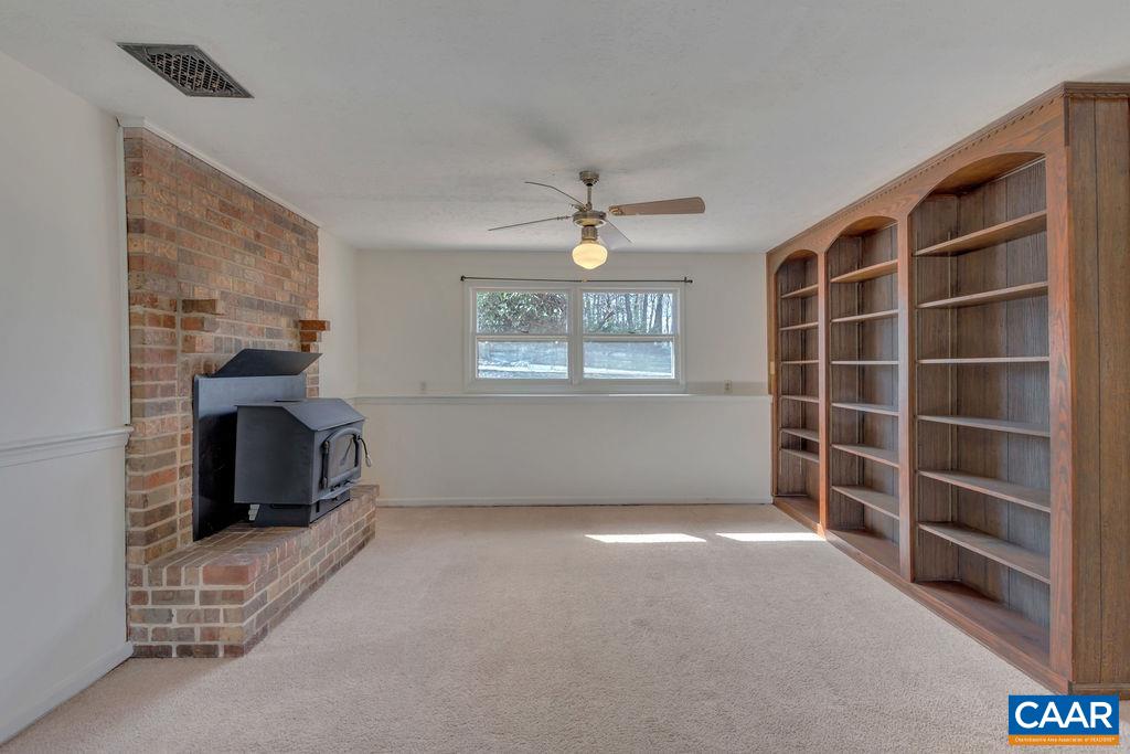 385 Gillums Ridge Road Charlottesville, VA 22903 - Photo 17 of 34 a view of an empty room with a window and fireplace