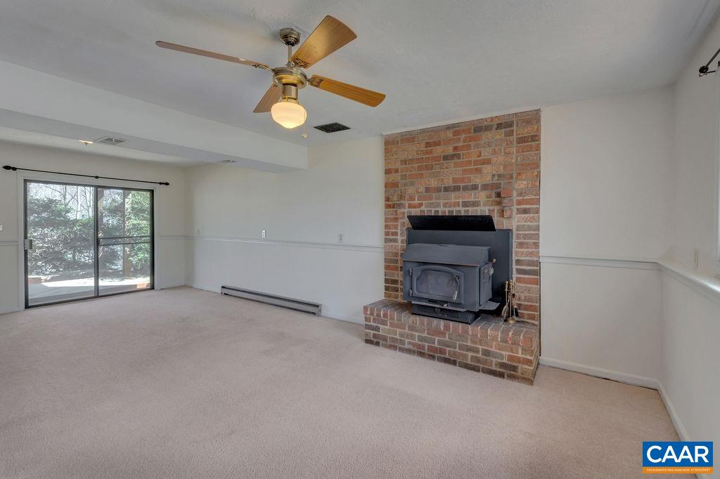 385 Gillums Ridge Road Charlottesville, VA 22903 - Photo 19 of 34 a view of an empty room with a fireplace and a window