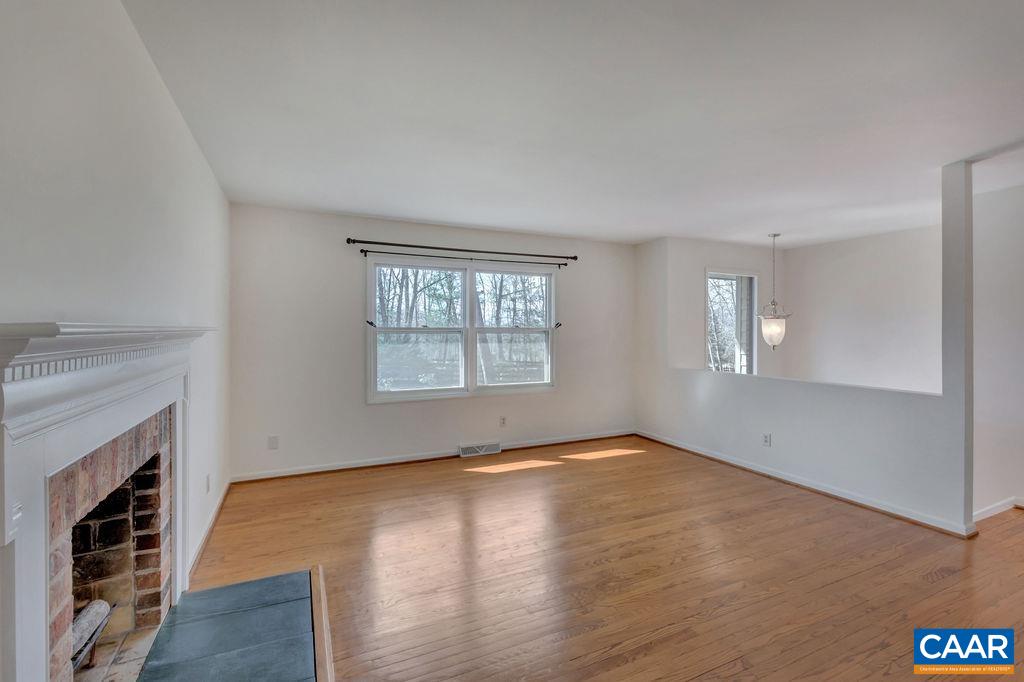 385 Gillums Ridge Road Charlottesville, VA 22903 - Photo 3 of 34 an empty room with windows and fireplace