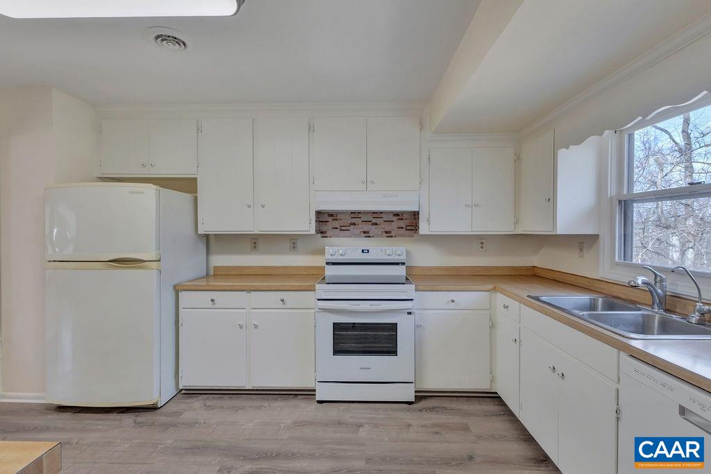385 Gillums Ridge Road Charlottesville, VA 22903 - Photo 5 of 34 a kitchen with cabinets appliances a sink and a window