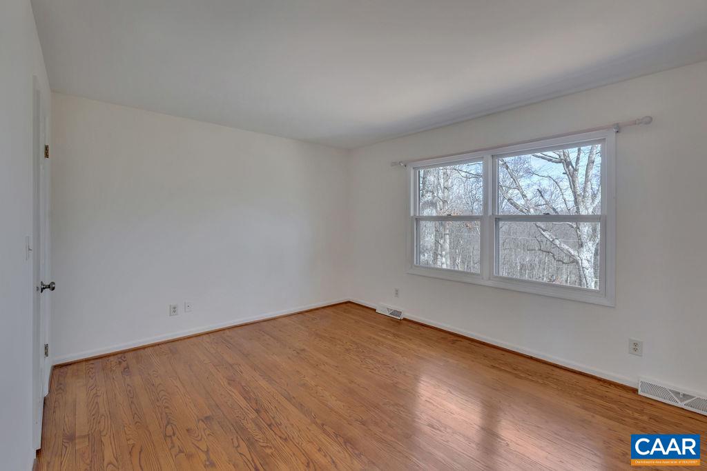 385 Gillums Ridge Road Charlottesville, VA 22903 - Photo 8 of 34 an empty room with a window
