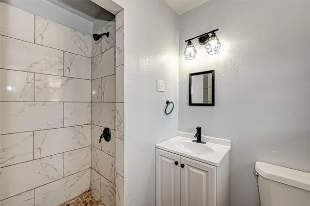 a bathroom with a toilet sink and mirror