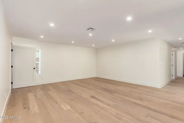 a view of a big room with wooden cabinet and a hallway