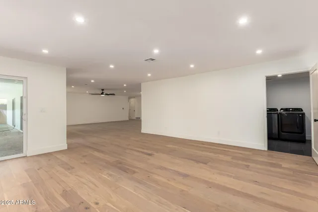 a kitchen with stainless steel appliances a sink a refrigerator and cabinets