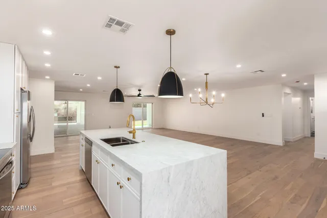 a kitchen with stainless steel appliances a sink stove and refrigerator