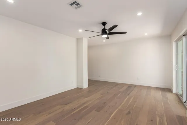 a bathroom with a double vanity sink mirror and a bath