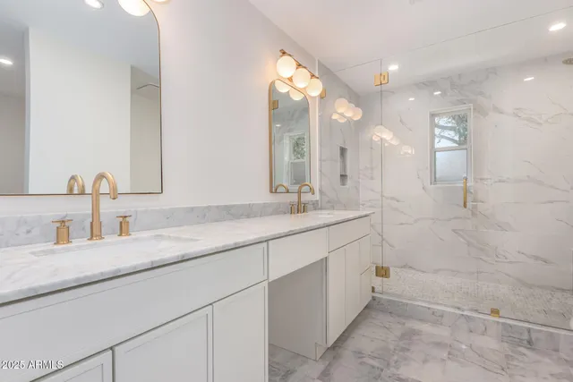 a bathroom with a granite countertop sink a toilet and shower