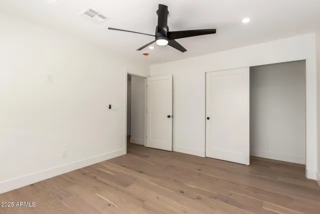 a bathroom with a granite countertop toilet sink and mirror