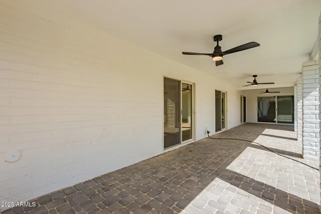 a view of a porch with furniture and a yard
