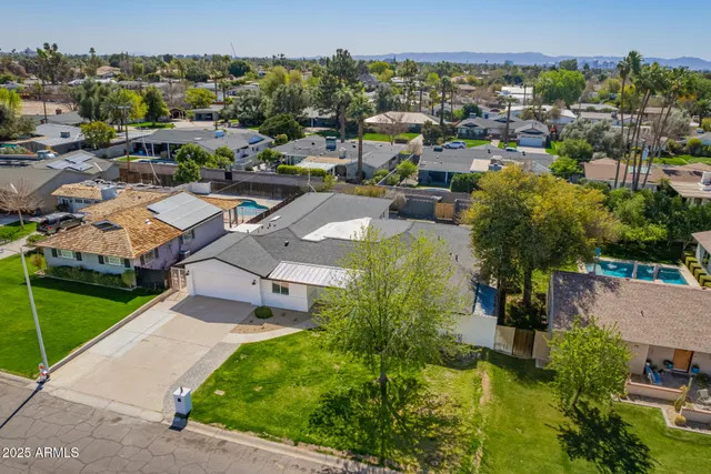 an aerial view of a house with a yard