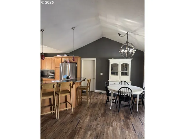 a dining room with furniture and wooden floor