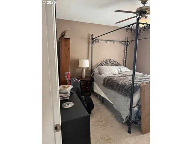 a bedroom with a bed and a table
