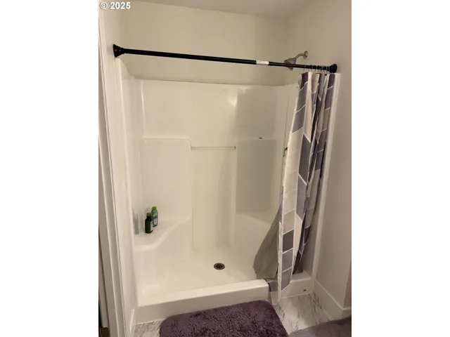 a bathroom with a glass shower door