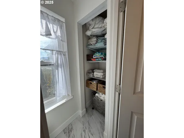 a view of a closet area with living room