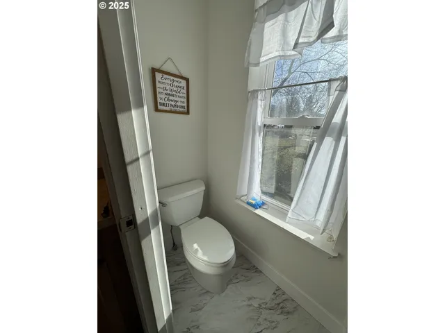 a white toilet sitting next to a bathroom sink