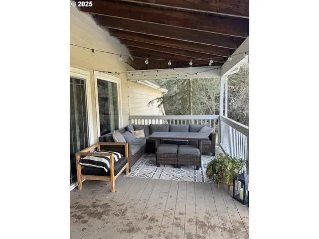 a view of a porch with furniture and a yard