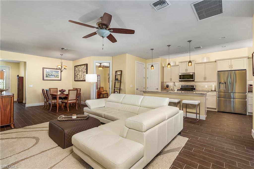 16309 Winfield Lane Naples, FL 34110 - Photo 1 of 35 a living room with stainless steel appliances furniture and a view of kitchen