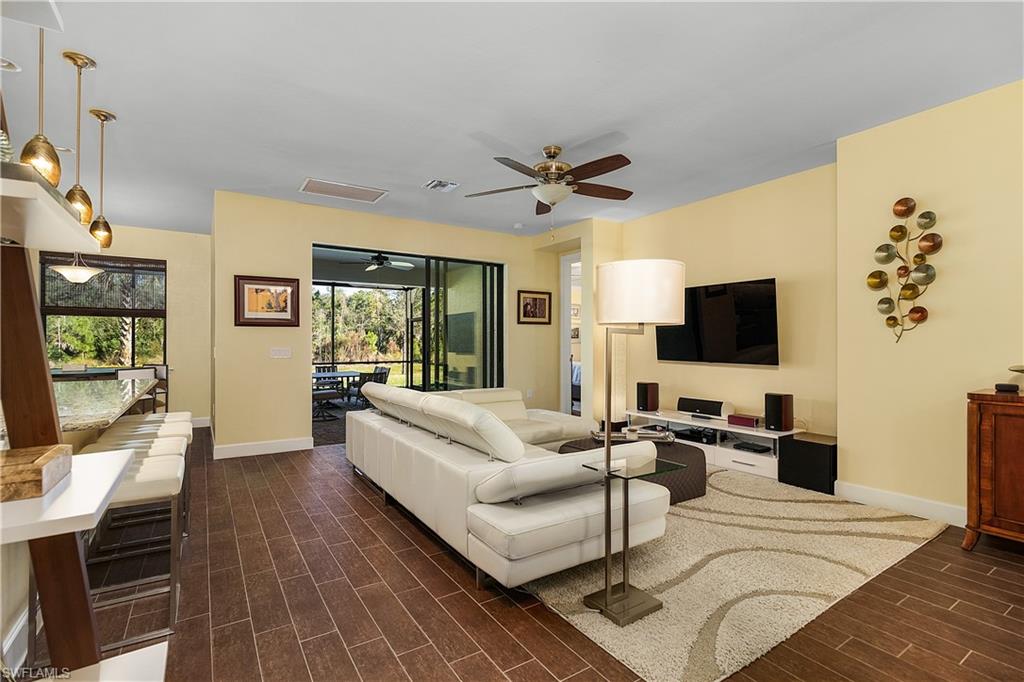 16309 Winfield Lane Naples, FL 34110 - Photo 13 of 35 a living room with furniture and a flat screen tv
