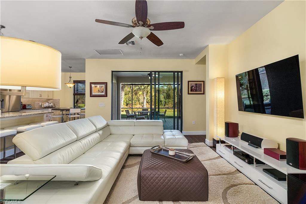16309 Winfield Lane Naples, FL 34110 - Photo 15 of 35 a living room with furniture and a flat screen tv