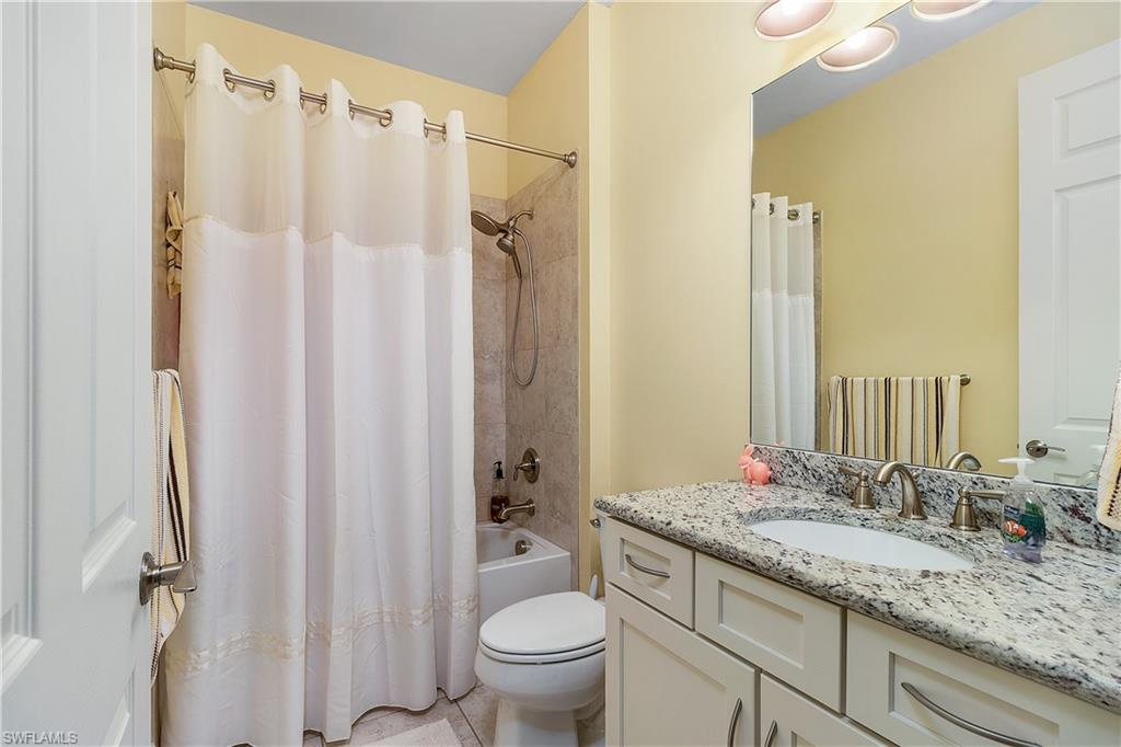 16309 Winfield Lane Naples, FL 34110 - Photo 16 of 35 a bathroom with a granite countertop sink toilet and shower